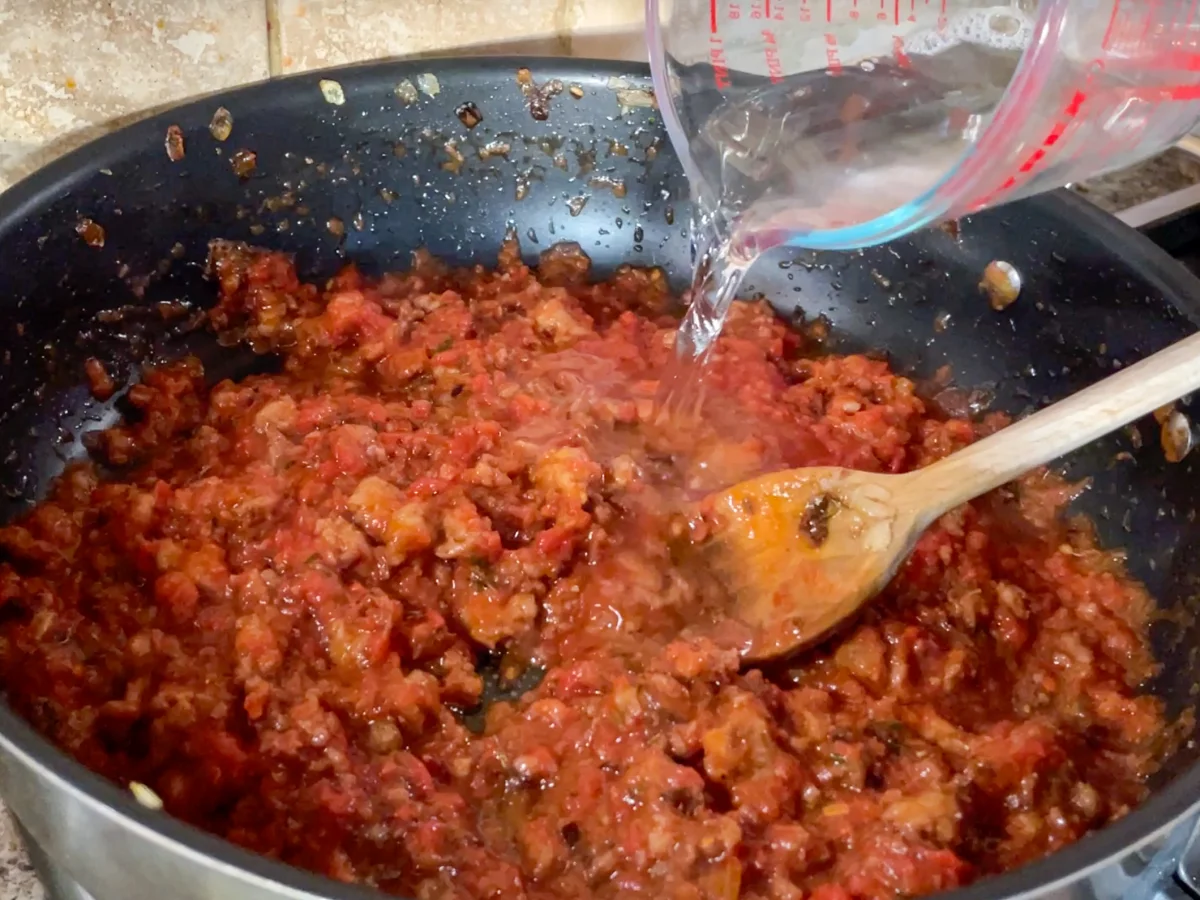 Adding water to loosen the sausage ragu