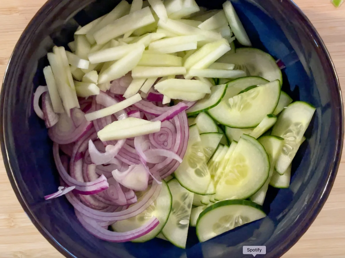 Apple, cucumber and red onion in a bowl