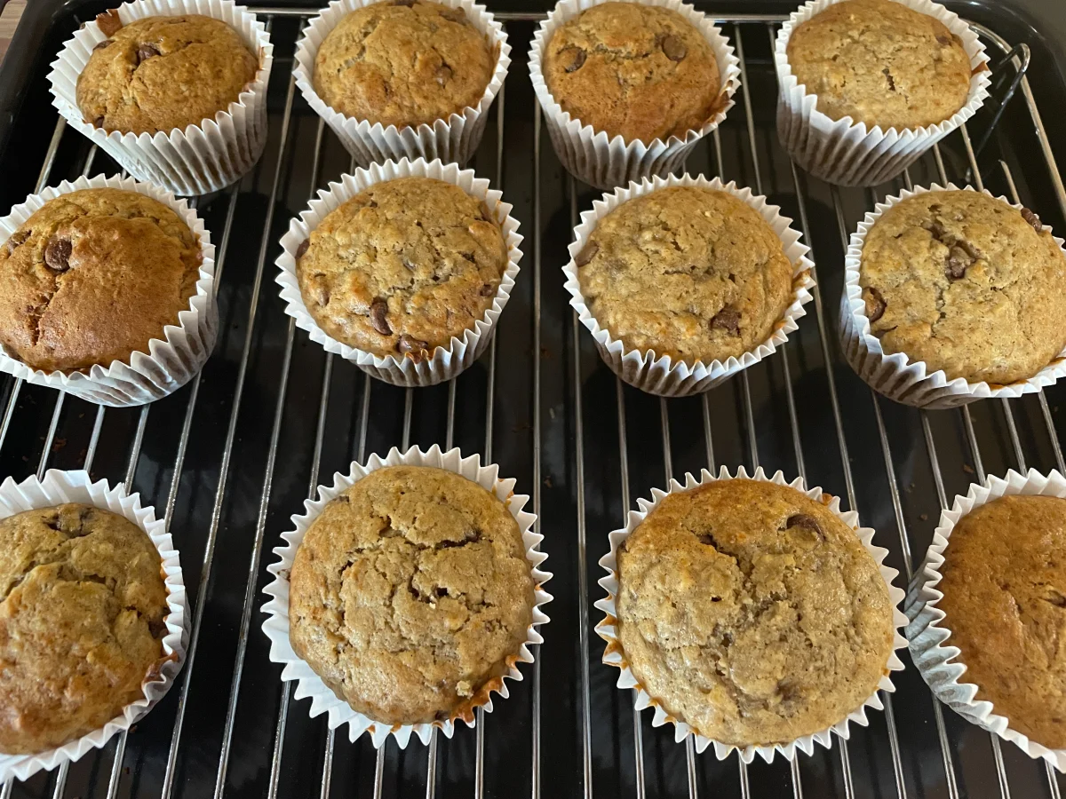 Banana chocolate chip muffins cooling on a wire rack