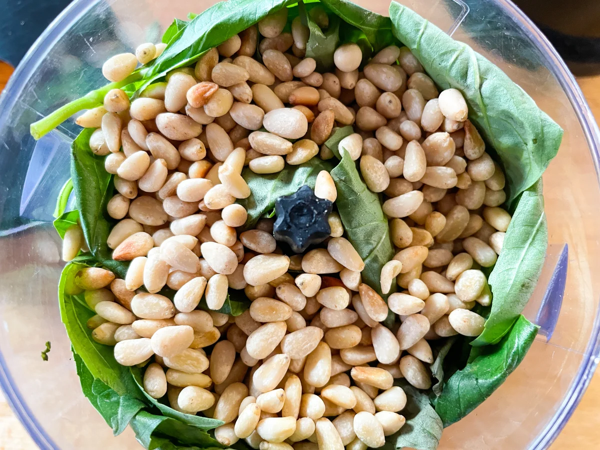 Basil and pine nuts in a food processor