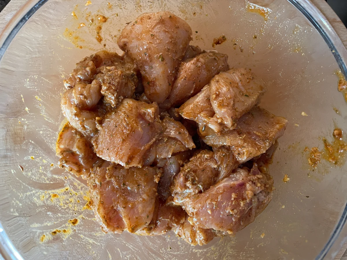 Chicken marinading in a bowl