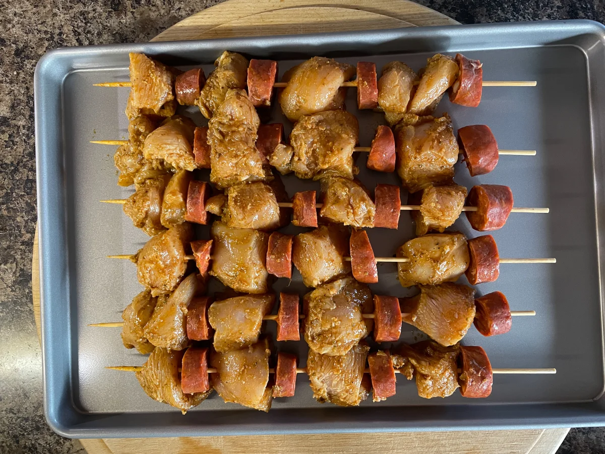 Completed chicken and chorizo skewers on a baking tray