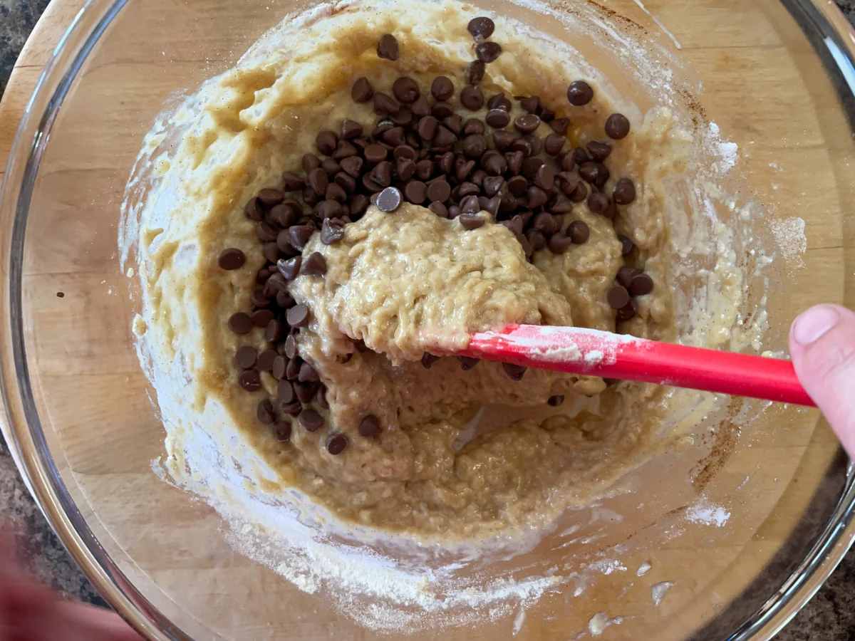 Folding chocolate chips into muffin batter