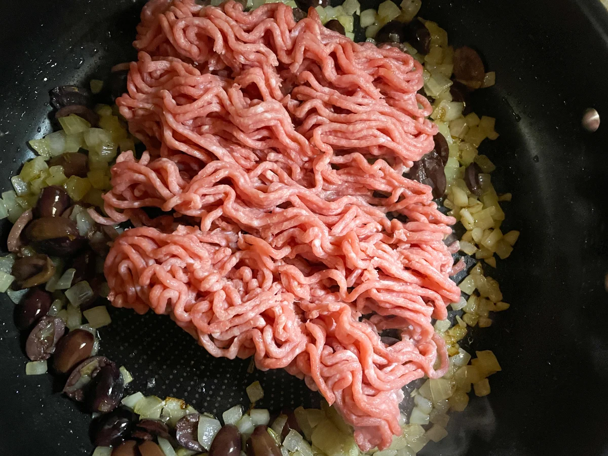 Pork mince added to the Kalamata olives and onions