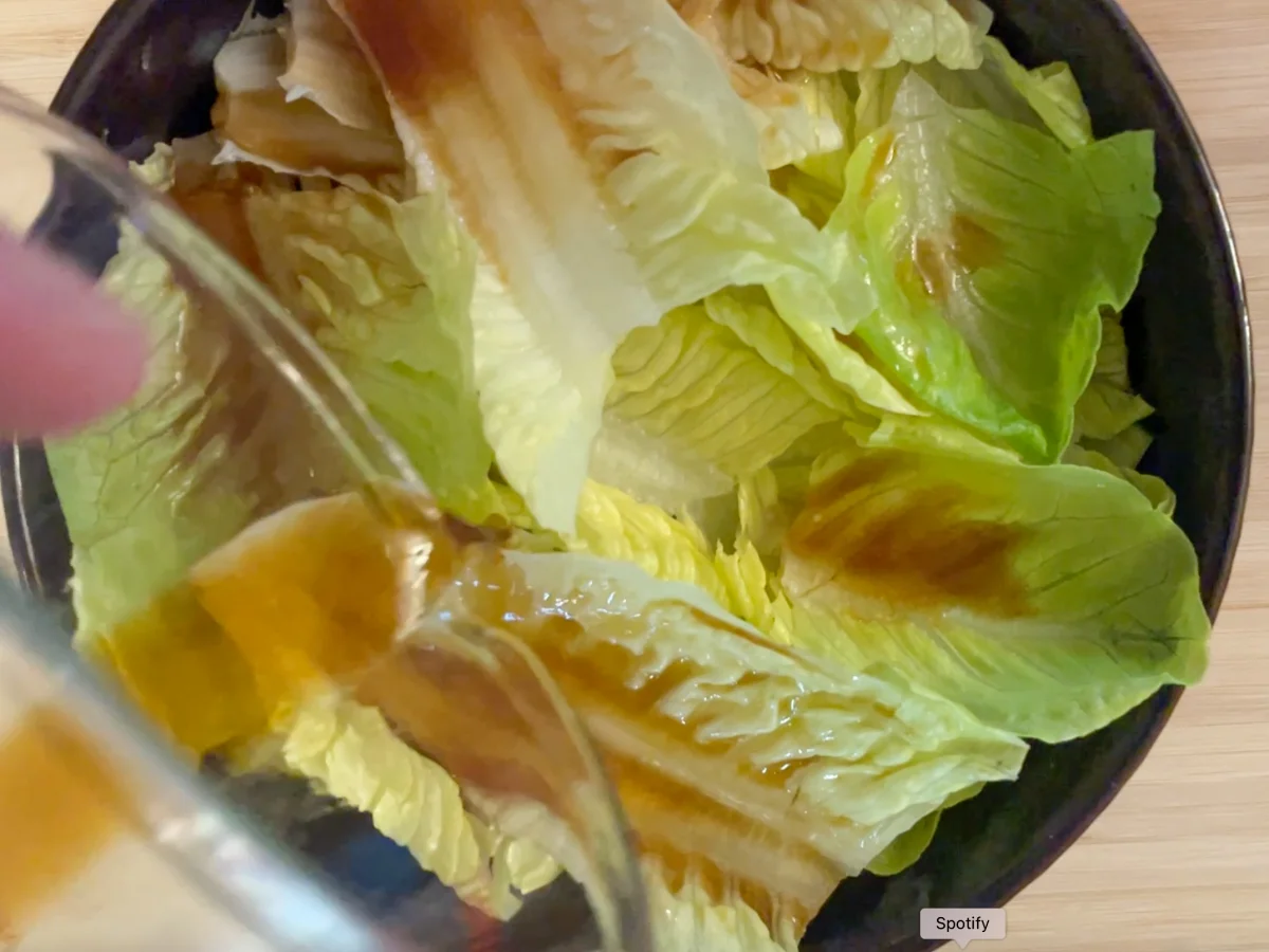 Pouring dressing onto Korean Style Salad