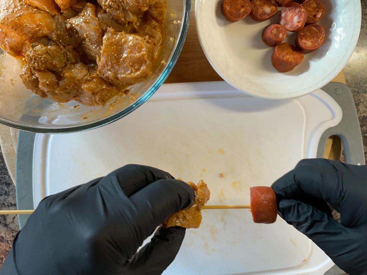 Threading the meat onto the skewers